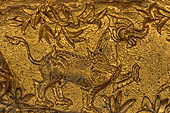 Luang Prabang, Laos - Wat Mai the gilded stucco engravings of the veranda. They narrate the Vessantara Jataka with various animals engraved at the base of the relief. 